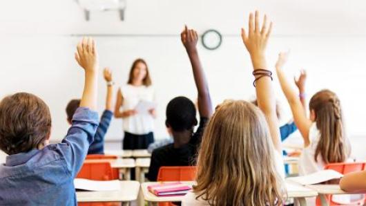 Students raising their hands.