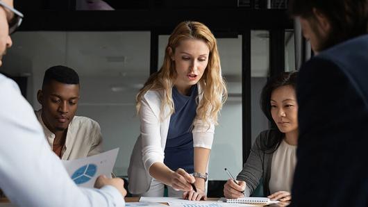 Young executives gathered around a conference table