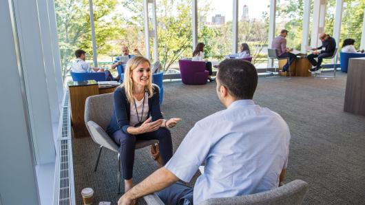 Female and Male executives engaged in conversation in Tata Hall