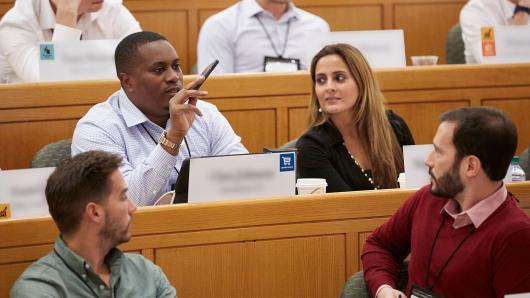 Diverse foursome of executives in an HBS classroom