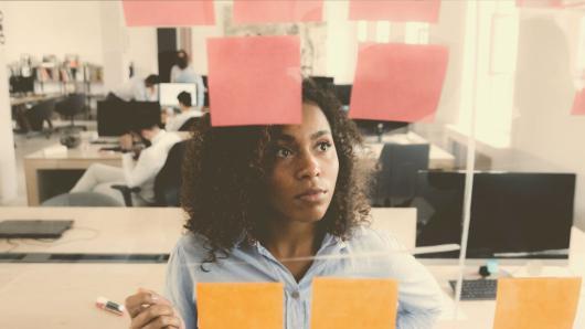 person looking at post-it notes